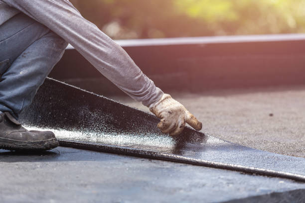 Professional Basement Waterproofing technician working in Foster, KY